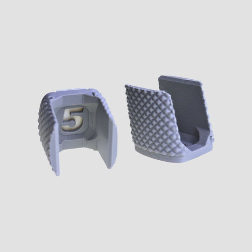 Two grey 5LAX lacrosse stick holders with textured diamond backs, one showing the gold 5 logo